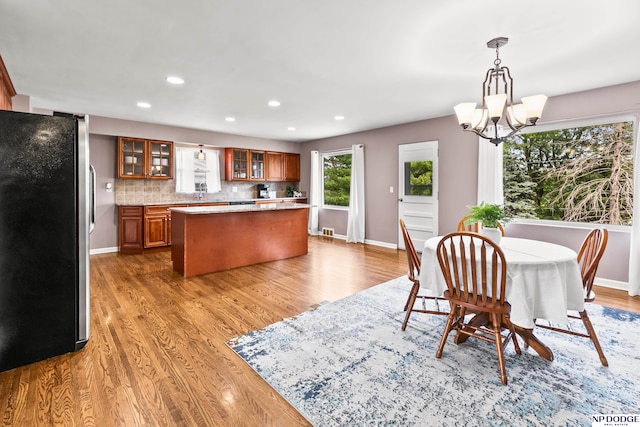 dining room with hardwood / wood-style floors and a chandelier