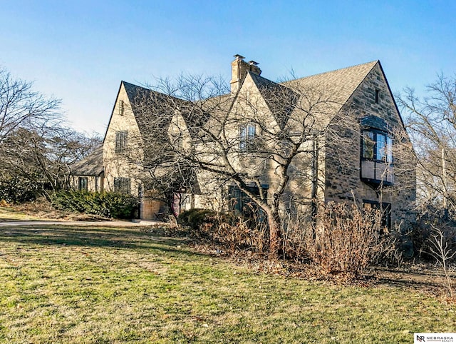 view of side of property with a yard