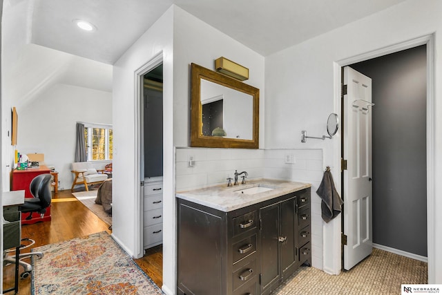 bathroom with hardwood / wood-style floors and vanity