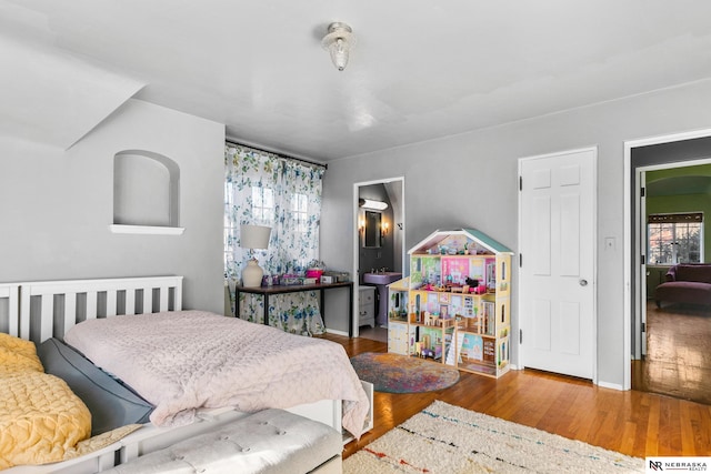 bedroom with hardwood / wood-style flooring