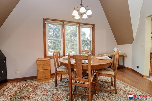 dining area featuring light hardwood / wood-style floors and an inviting chandelier