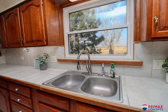 kitchen featuring tasteful backsplash and sink