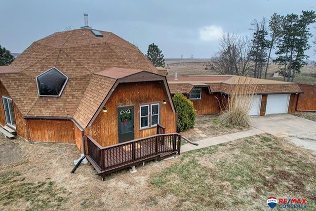 view of front of home featuring a garage and a deck