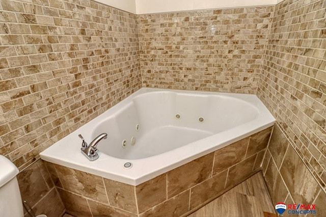 bathroom with tiled bath and toilet