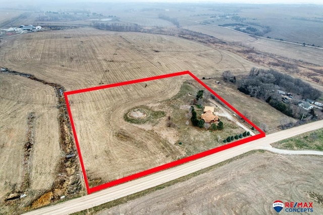 birds eye view of property with a rural view