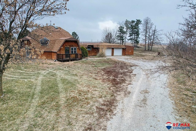 view of front of house with a garage and a deck