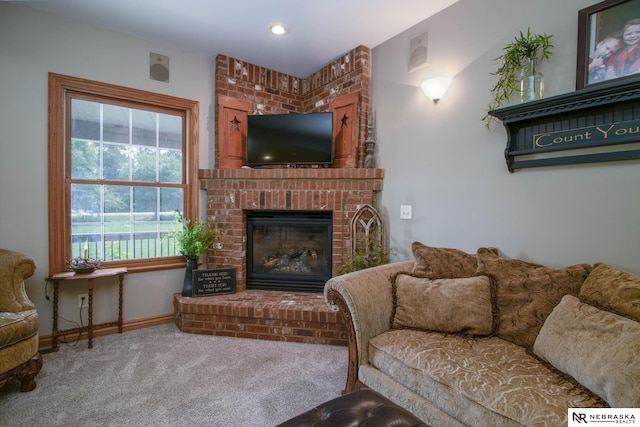 carpeted living room featuring a fireplace