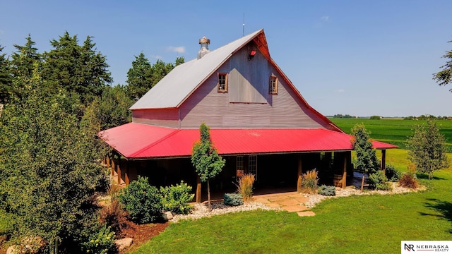 view of front of property with a rural view and a front lawn