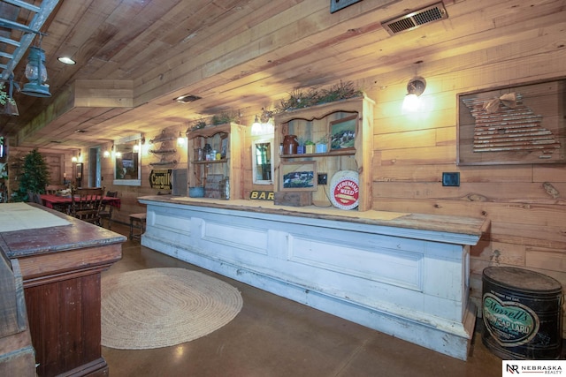 bar featuring wood walls and wood ceiling