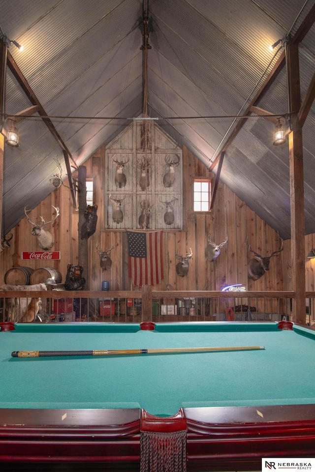 game room featuring vaulted ceiling, wooden walls, and pool table