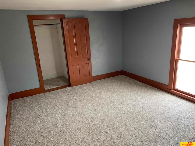 unfurnished bedroom featuring carpet floors and a closet