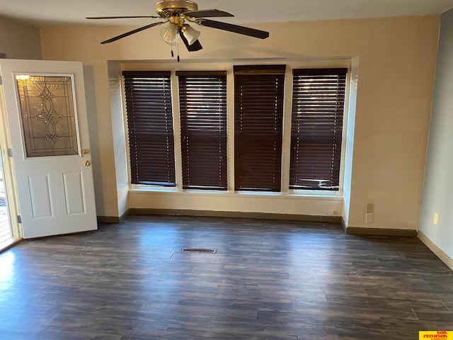 interior space featuring ceiling fan and dark wood-type flooring