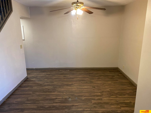 spare room with dark hardwood / wood-style floors, ceiling fan, and a textured ceiling