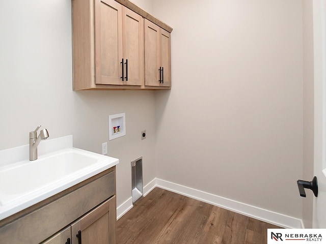 washroom featuring electric dryer hookup, cabinets, dark wood-type flooring, sink, and hookup for a washing machine