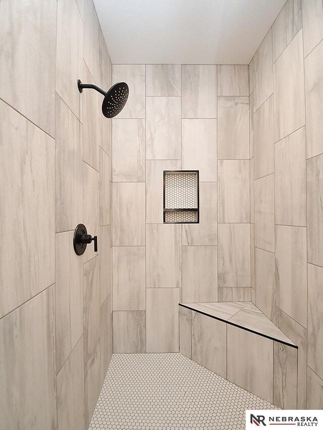 bathroom with tiled shower