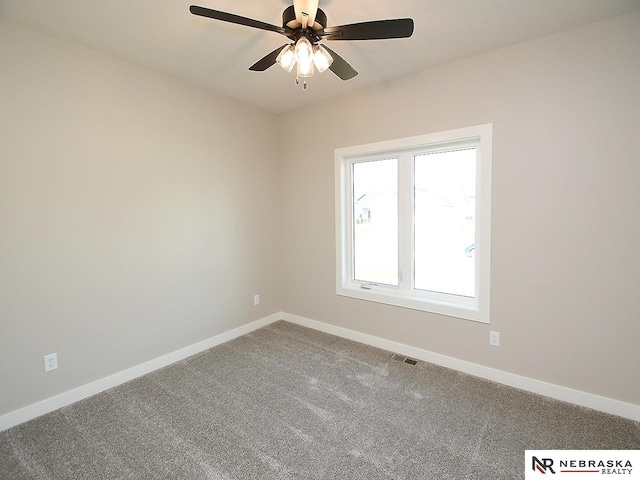 carpeted spare room featuring ceiling fan