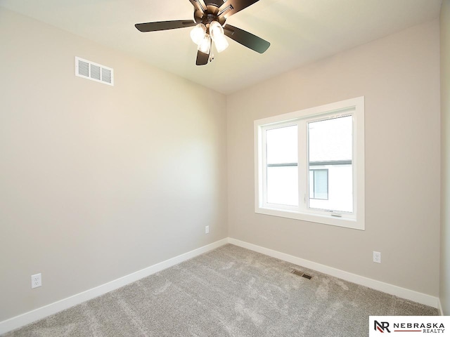 spare room featuring ceiling fan and light colored carpet