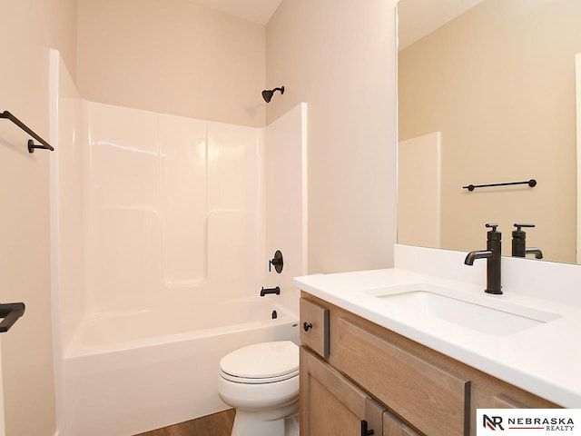 full bathroom with hardwood / wood-style flooring, vanity, shower / bathtub combination, and toilet