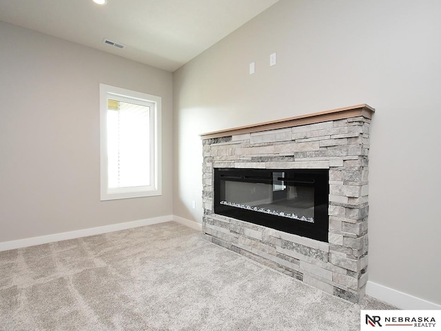 interior details featuring a fireplace and carpet floors