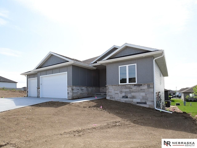 ranch-style home featuring a garage, concrete driveway, board and batten siding, and stone siding