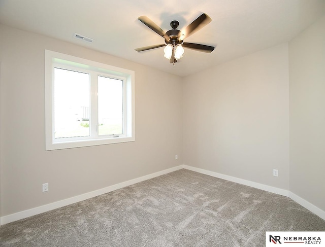 spare room featuring ceiling fan and carpet floors