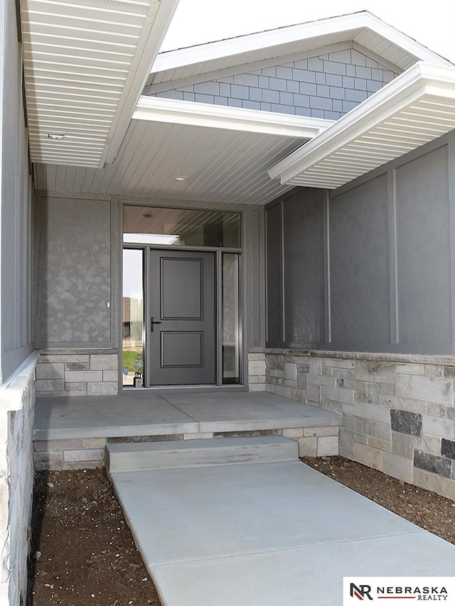 view of exterior entry with covered porch