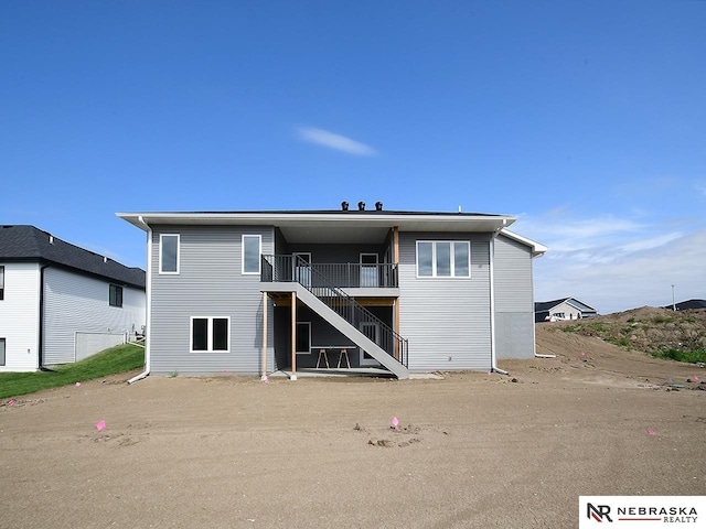 rear view of property with a wooden deck