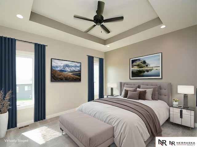 bedroom with carpet, recessed lighting, a raised ceiling, visible vents, and baseboards