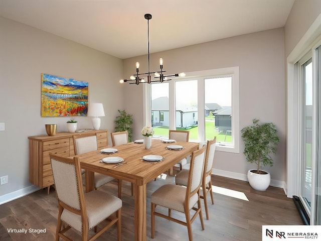 dining space with a chandelier, dark wood finished floors, and baseboards