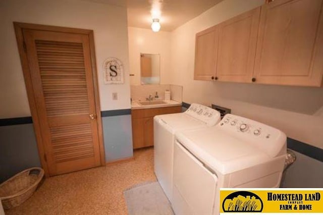 laundry room with washer and clothes dryer, cabinets, and sink