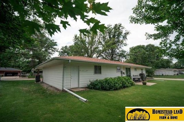 back of house with a lawn