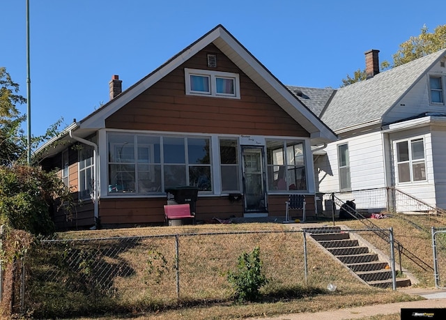 bungalow-style house featuring a sunroom