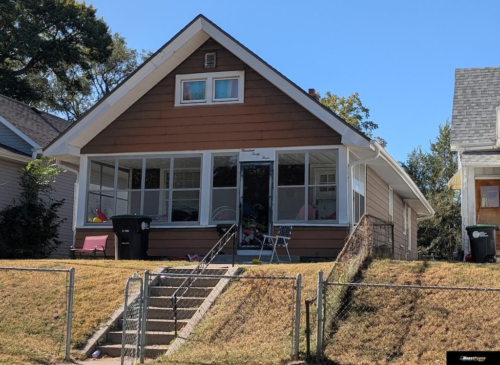 bungalow-style home with a front lawn