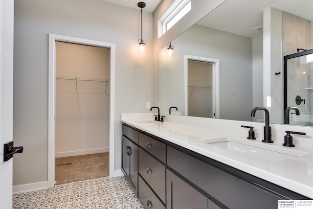 bathroom with vanity and a shower with shower door