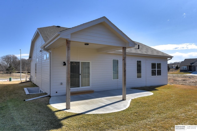 rear view of house with a yard and a patio