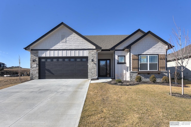 view of front of property featuring a garage and a front lawn