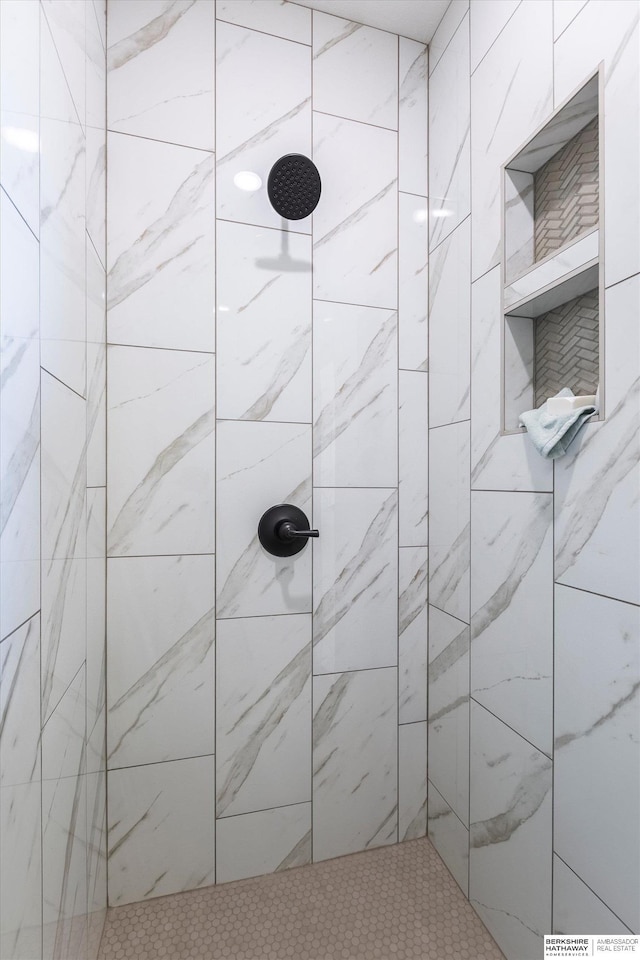 bathroom with a tile shower