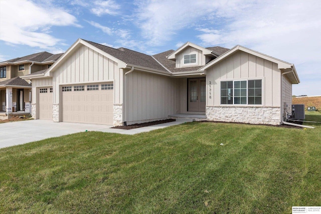 view of front facade featuring a garage, a front lawn, and cooling unit