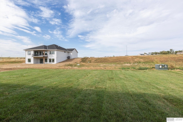 view of yard featuring a balcony and a rural view