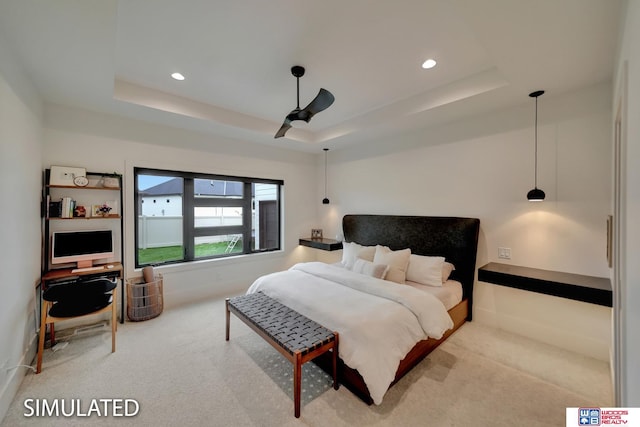 bedroom featuring carpet, ceiling fan, and a raised ceiling