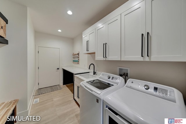 laundry room with sink, cabinets, separate washer and dryer, and light tile patterned floors