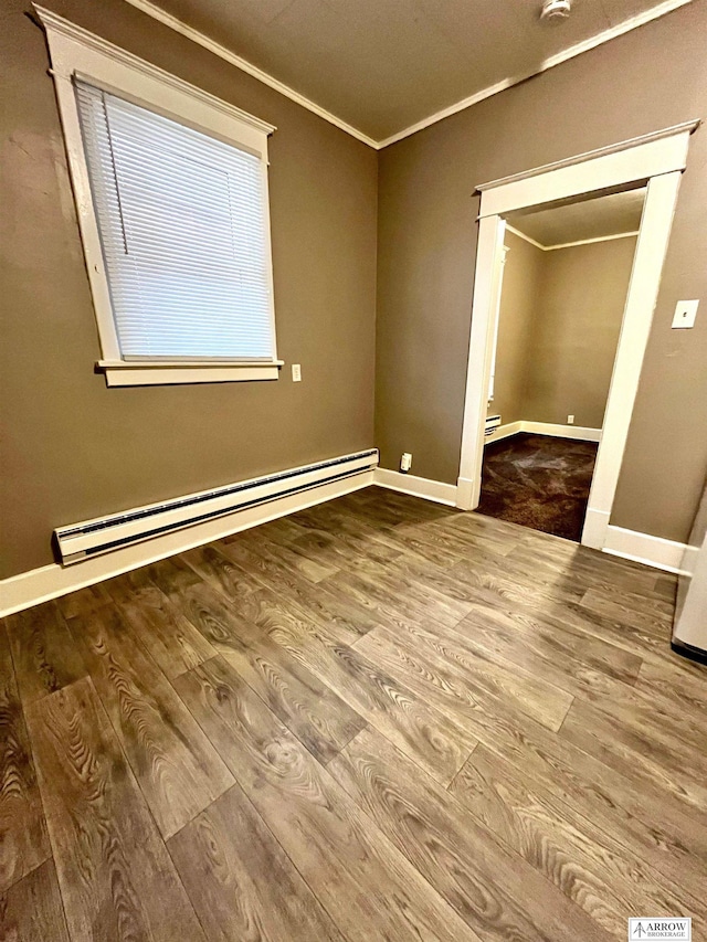 unfurnished bedroom featuring crown molding, a closet, hardwood / wood-style floors, and a baseboard radiator