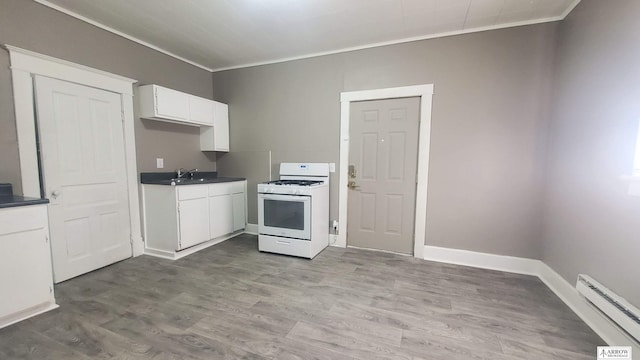 kitchen with white cabinetry, light wood-type flooring, white range with gas stovetop, and baseboard heating