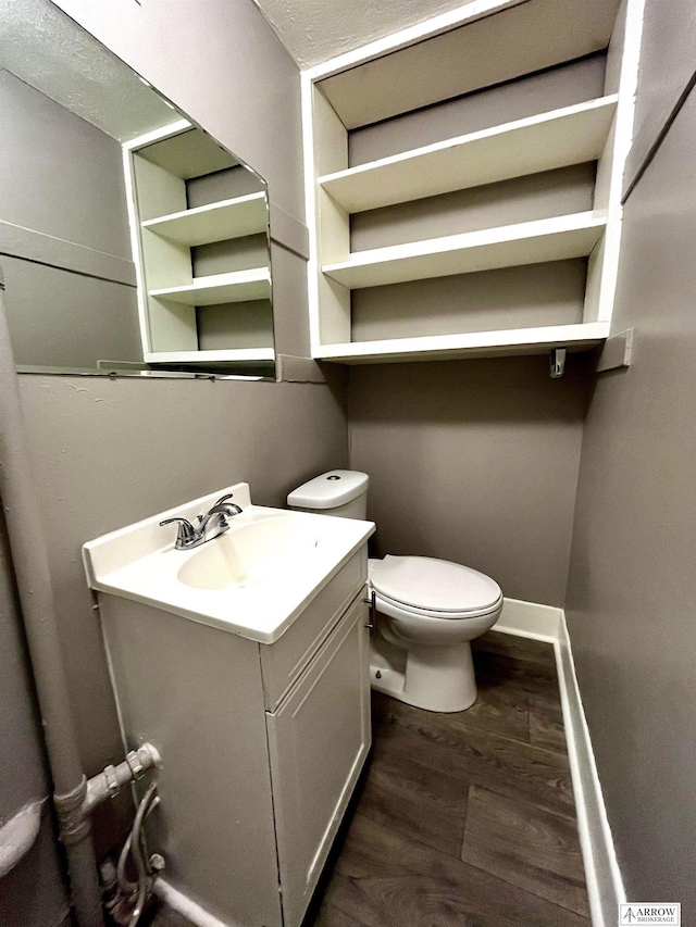 bathroom with vanity, hardwood / wood-style flooring, and toilet