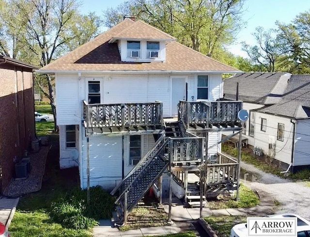 rear view of house featuring central AC