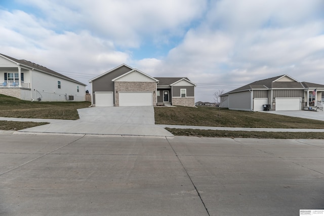 view of front of home featuring a front yard and a garage