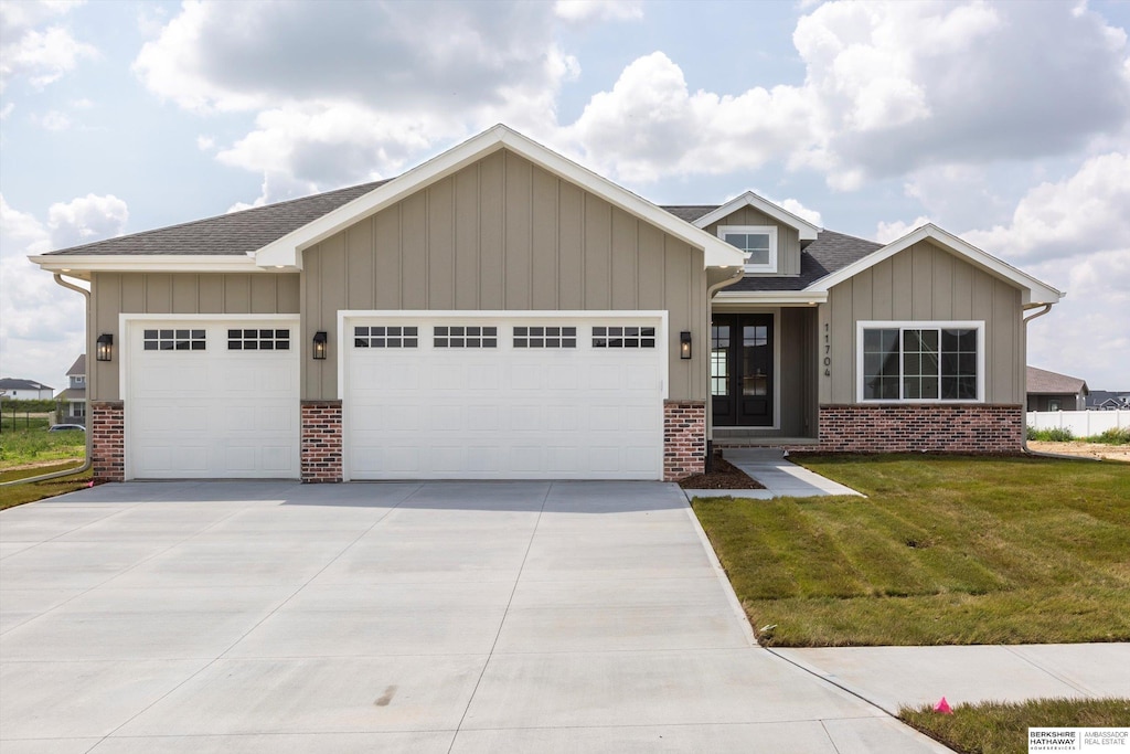 11704 S 119th St, Papillion, NE 68046 - view of front of house featuring brick siding, an attached garage, and a front yard
