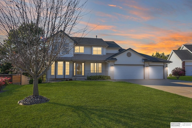 view of front of home with a lawn and a garage