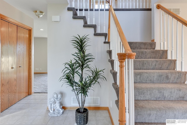 stairway with tile patterned floors