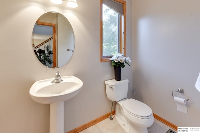 bathroom featuring tile patterned floors, toilet, and sink